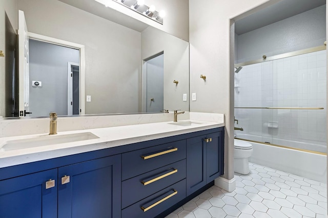 full bathroom with vanity, toilet, tile patterned flooring, and combined bath / shower with glass door