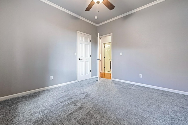 carpeted empty room with ceiling fan and ornamental molding