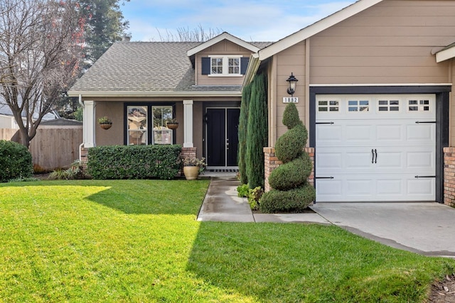 view of front of home featuring a garage, a front lawn, and covered porch