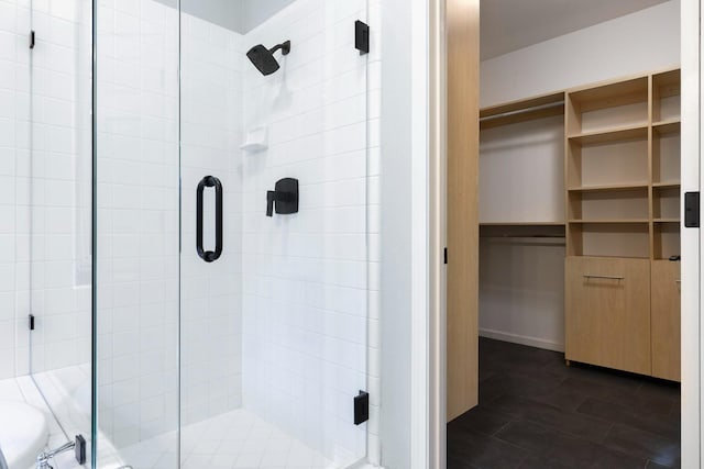 bathroom featuring a shower with shower door