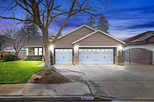 view of front of property with a garage and a yard