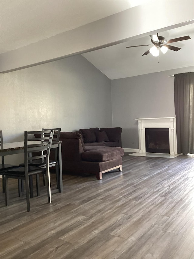 living room featuring hardwood / wood-style flooring, vaulted ceiling, and ceiling fan