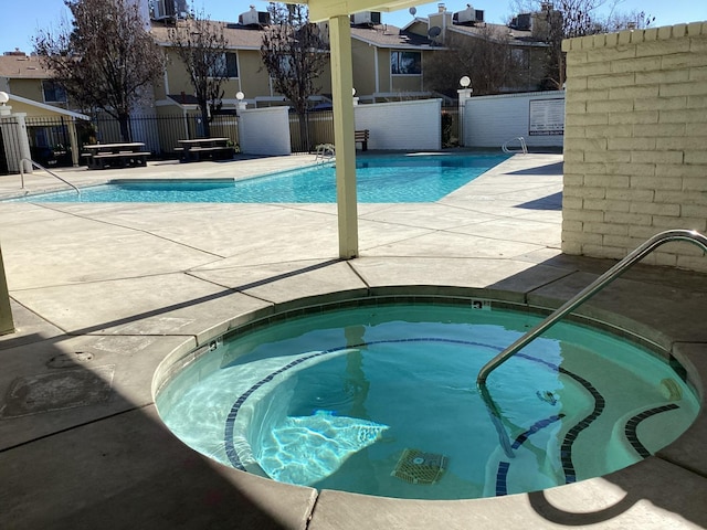 view of pool featuring a hot tub