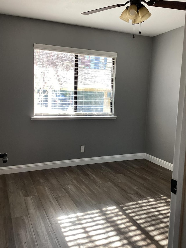 empty room featuring ceiling fan and dark hardwood / wood-style floors