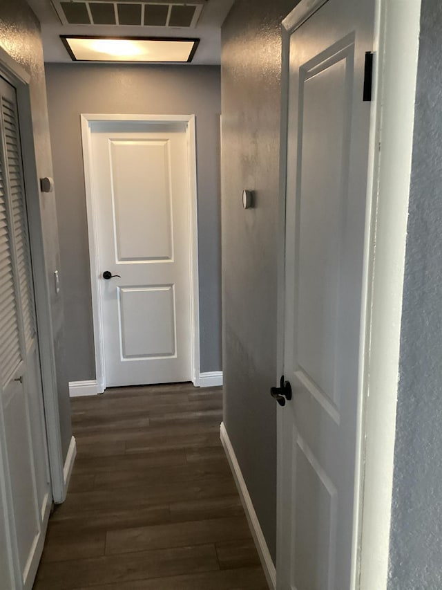 hallway with dark wood-type flooring