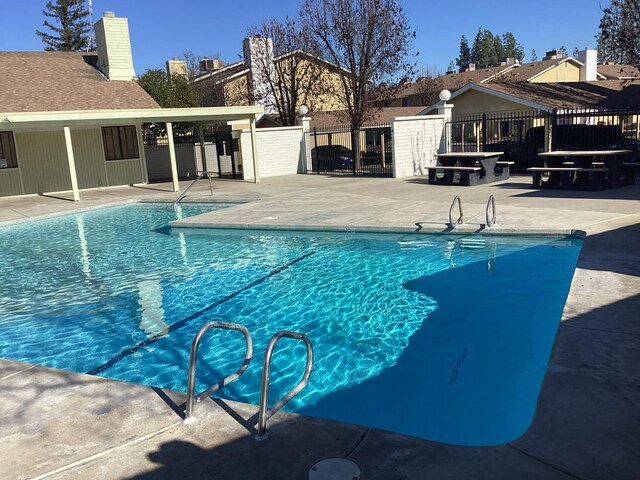 view of swimming pool featuring a patio area