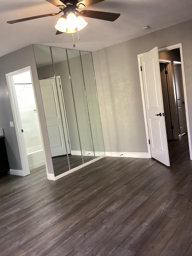 unfurnished bedroom featuring dark hardwood / wood-style flooring and ceiling fan