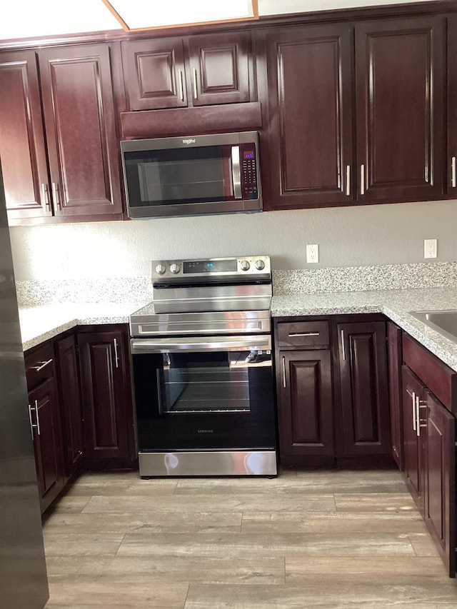 kitchen with light hardwood / wood-style flooring and stainless steel appliances