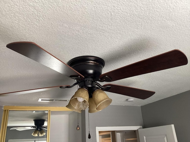 details with a textured ceiling and ceiling fan