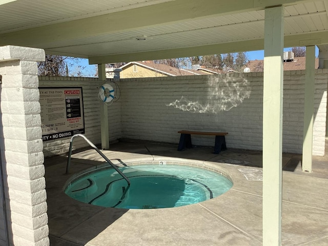 view of pool featuring a hot tub