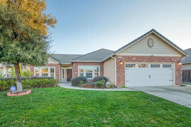 ranch-style house with a garage and a front yard