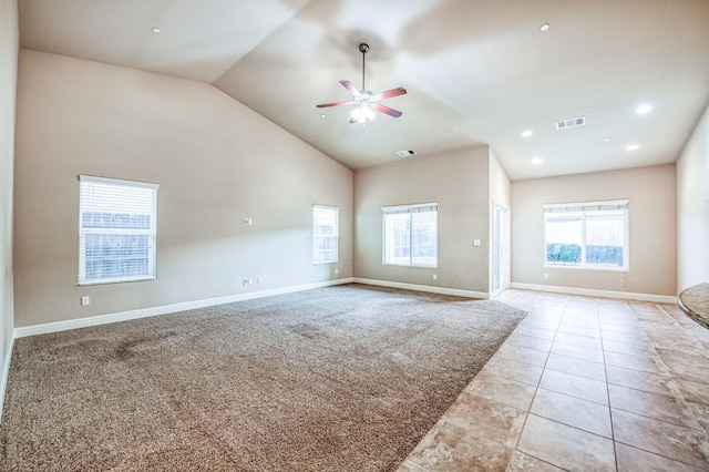 interior space featuring ceiling fan, light colored carpet, and high vaulted ceiling