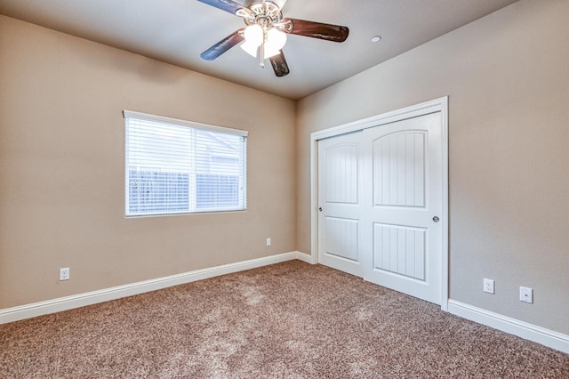 unfurnished bedroom with a closet, ceiling fan, and carpet flooring