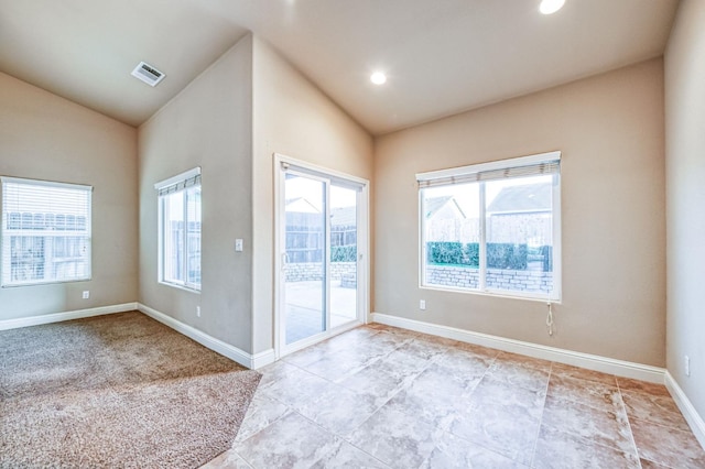 spare room with lofted ceiling