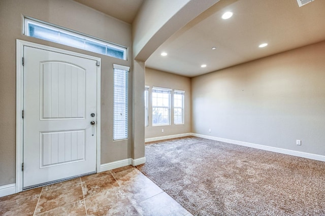 view of carpeted entrance foyer