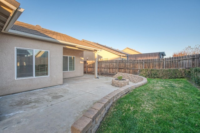 view of yard featuring a patio and an outdoor fire pit