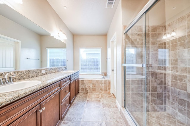 bathroom featuring shower with separate bathtub and vanity