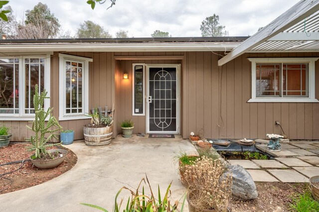 property entrance featuring a patio