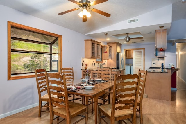 41925 Longhollow Dr, Coarsegold, CA 93614 - dining space with separate washer and dryer, light wood-type flooring, visible vents, a ceiling fan, and lofted ceiling