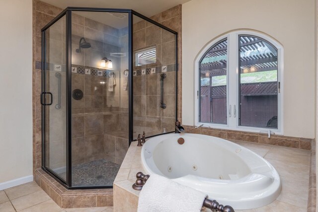 bathroom featuring tile patterned flooring and plus walk in shower