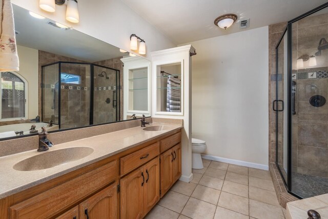 bathroom with vanity, an enclosed shower, tile patterned flooring, and toilet