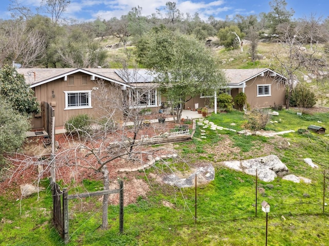 rear view of property with a yard and a patio area