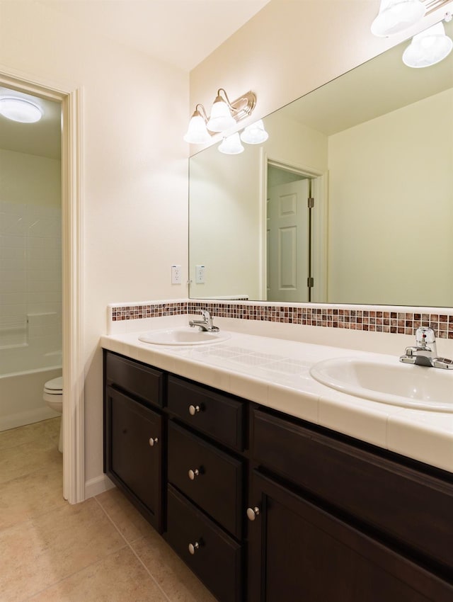 full bathroom featuring tile patterned floors, vanity, toilet, and tub / shower combination