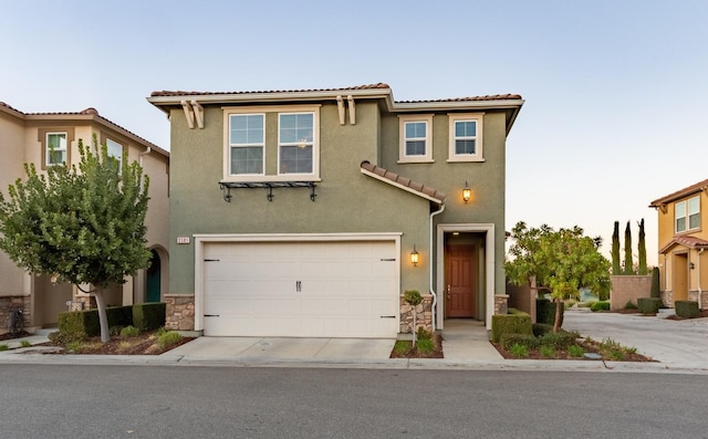 mediterranean / spanish-style house with a garage