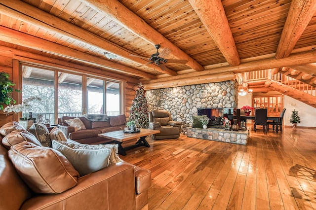 12755 Rusty Spur Ln, Clovis, CA 93619 - living room featuring wood ceiling, ceiling fan, hardwood / wood-style floors, beam ceiling, and a stone fireplace