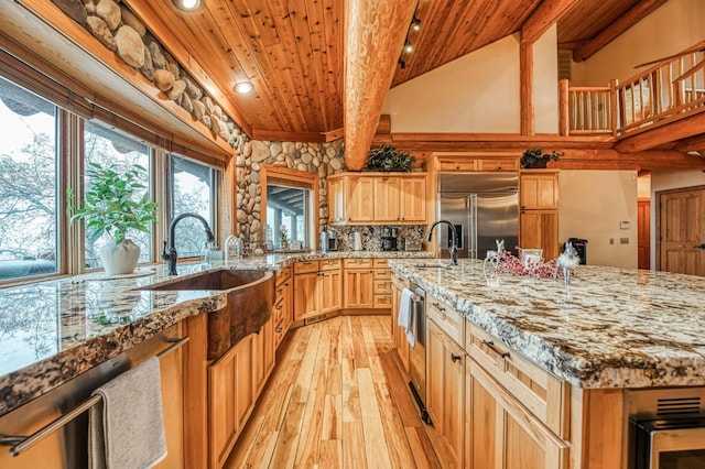 kitchen featuring stainless steel appliances, sink, beam ceiling, wooden ceiling, and light hardwood / wood-style floors