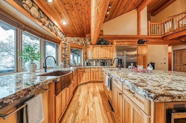 12755 Rusty Spur Ln, Clovis, CA 93619 - kitchen with built in refrigerator, wood ceiling, light wood-style floors, a sink, and beamed ceiling