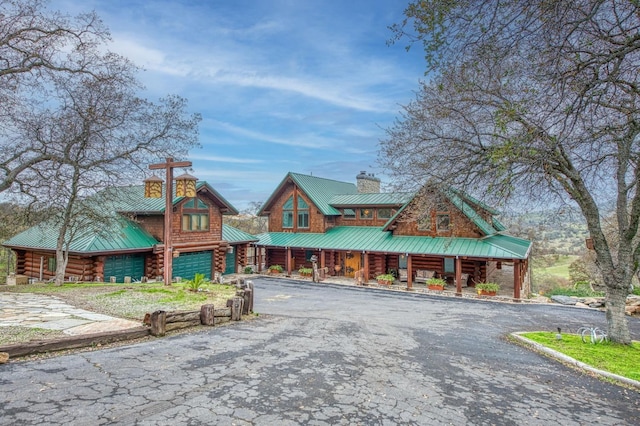 log home with a porch and a garage