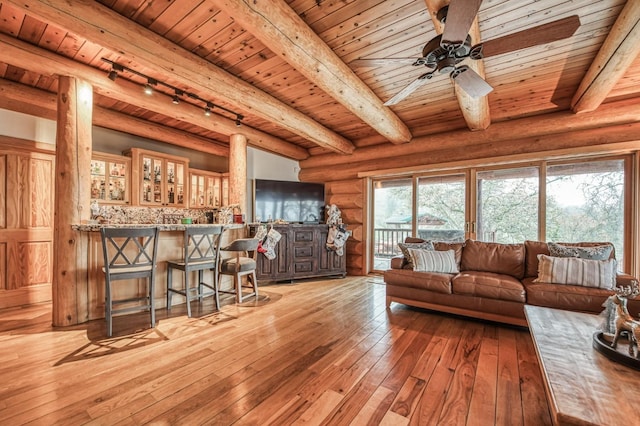 12755 Rusty Spur Ln, Clovis, CA 93619 - living room featuring wooden ceiling, track lighting, light wood-style flooring, beamed ceiling, and ceiling fan