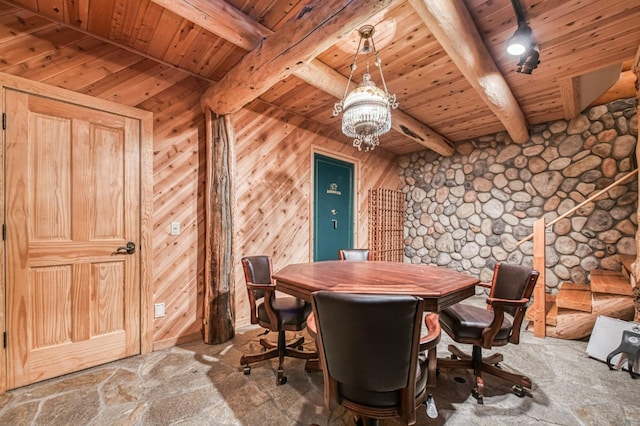 12755 Rusty Spur Ln, Clovis, CA 93619 - dining area with wooden ceiling, beamed ceiling, a chandelier, wooden walls, and stone finish floors