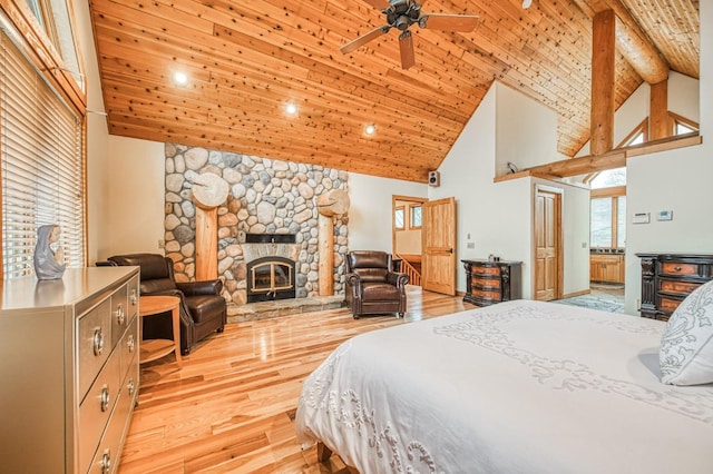 bedroom featuring ceiling fan, light hardwood / wood-style flooring, high vaulted ceiling, a fireplace, and wood ceiling