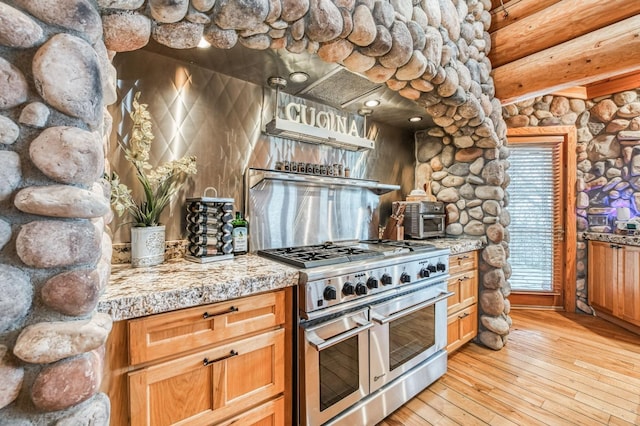 12755 Rusty Spur Ln, Clovis, CA 93619 - kitchen featuring double oven range, light wood-style floors, tile counters, and a wood stove