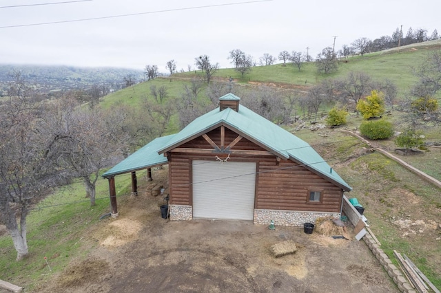 exterior space with a rural view and a garage