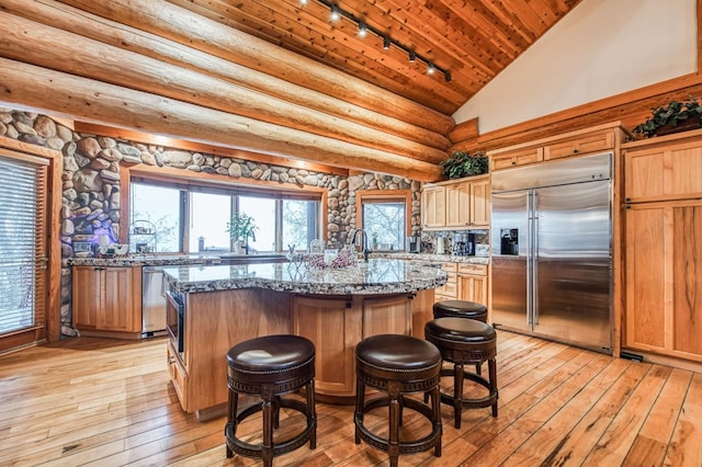 12755 Rusty Spur Ln, Clovis, CA 93619 - kitchen featuring built in fridge, track lighting, wood ceiling, light wood-style flooring, and lofted ceiling