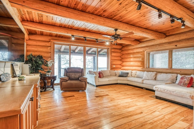 12755 Rusty Spur Ln, Clovis, CA 93619 - living room with track lighting, wooden ceiling, rustic walls, light wood-style floors, and beam ceiling