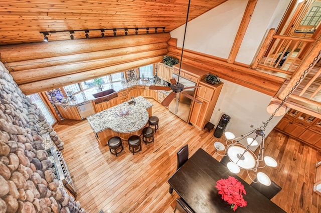 12755 Rusty Spur Ln, Clovis, CA 93619 - living room featuring wooden ceiling, log walls, hardwood / wood-style floors, and high vaulted ceiling