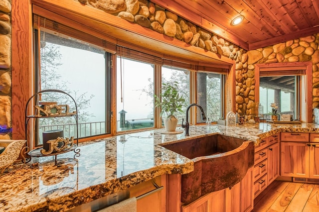 12755 Rusty Spur Ln, Clovis, CA 93619 - kitchen with light stone countertops, a sink, wood ceiling, and light wood finished floors