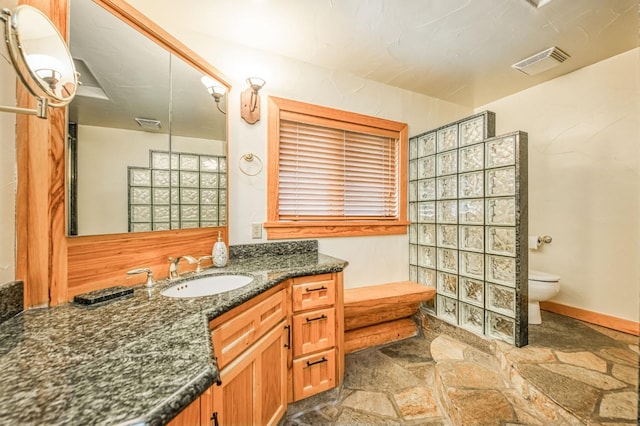 12755 Rusty Spur Ln, Clovis, CA 93619 - full bath with stone tile floors, toilet, vanity, and baseboards