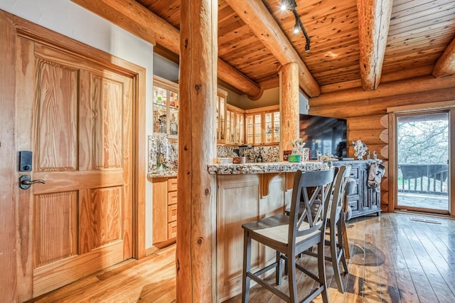 12755 Rusty Spur Ln, Clovis, CA 93619 - bar area with light wood finished floors, wood ceiling, beamed ceiling, log walls, and healthy amount of natural light