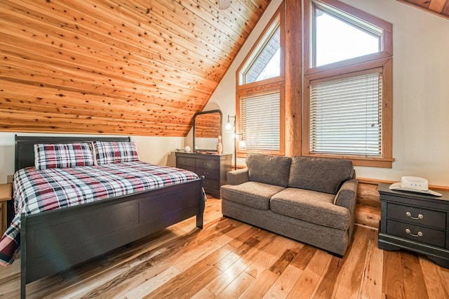 bedroom with light hardwood / wood-style flooring, wood ceiling, and vaulted ceiling