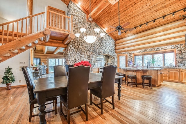 12755 Rusty Spur Ln, Clovis, CA 93619 - dining room with high vaulted ceiling, light wood-type flooring, wood ceiling, rustic walls, and beam ceiling