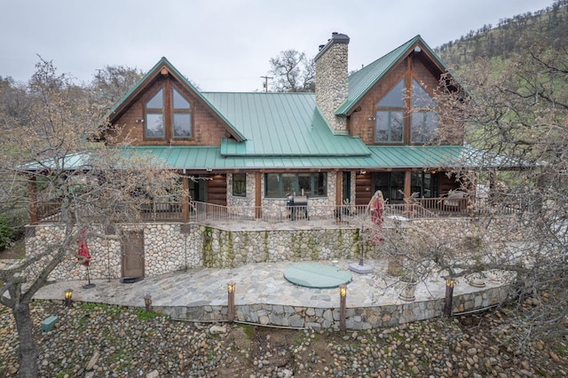 back of property featuring covered porch