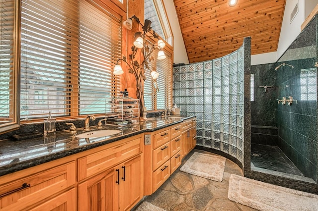 bathroom with tiled shower, vanity, vaulted ceiling, and wood ceiling