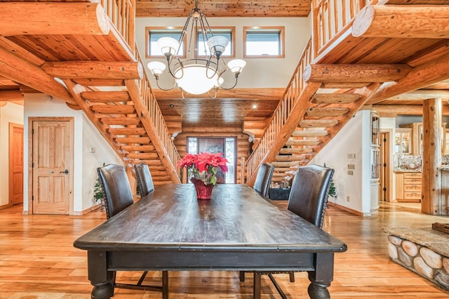 12755 Rusty Spur Ln, Clovis, CA 93619 - dining area with stairway, rustic walls, light wood-type flooring, a chandelier, and plenty of natural light