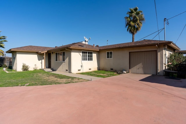 view of front of house featuring a garage and a front lawn