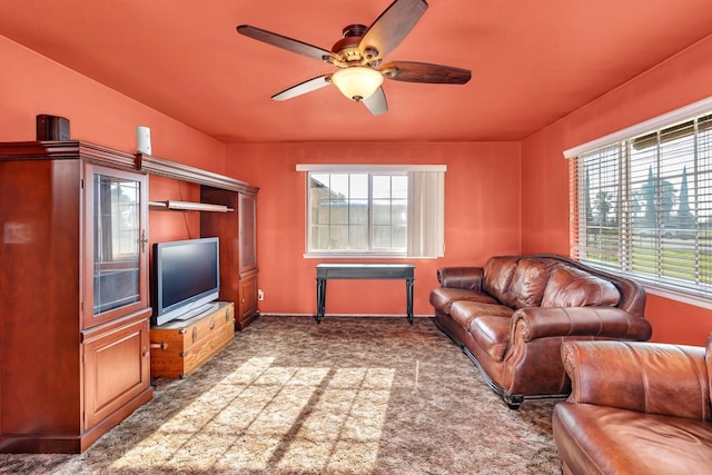 carpeted living room featuring ceiling fan